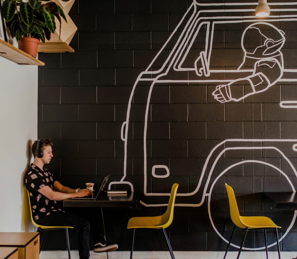 A man working on a laptop at a cafe table